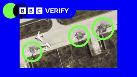 BBC A satellite image showing damaged Russian planes on a runway. Three damaged jets are circled in the photo, which is imposed over the BBC Verify colours and accompanied by the BBC Verify logo in the top left corner.