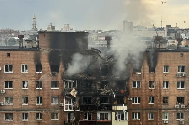 A view shows an burned and damaged apartment building hit by a Russian drone strike