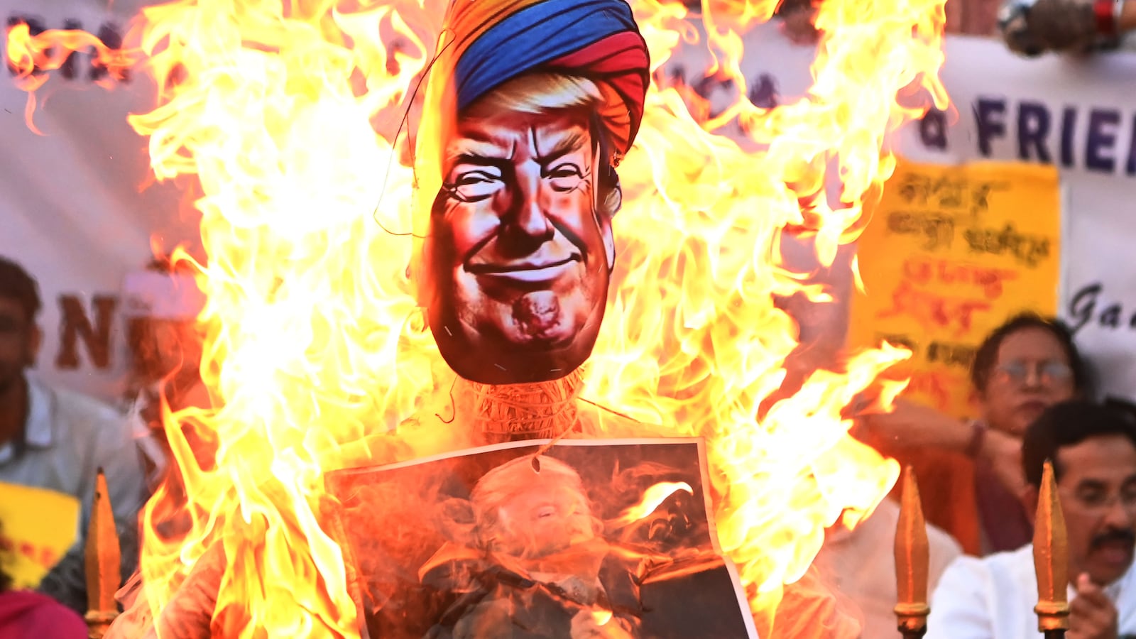 Members of India's main opposition party, the National Congress, burn an effigy of U.S. President Donald Trump in Kolkata, India, on May 14, 2025. They protest against America's interference in Indian internal affairs and the grouping of India and Pakistan in the same bracket regarding the recent war issue. (Photo by Gautam Bose/NurPhoto via Getty Images)