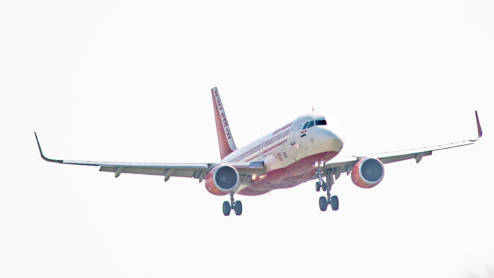 Air India Airbus A320 aircraft as seen flying over the mountains of Kathmandu valley and landing in Tribhuvan International Airport KTM.