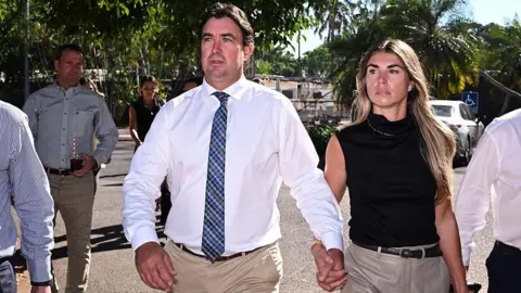 AFP via Getty Images Matt Wright (L), the star of Netflix show Wild Croc Territory and National Geographic's Outback Wrangler, arrives with his wife Kaia Wright (R) at the Supreme Court in Darwin