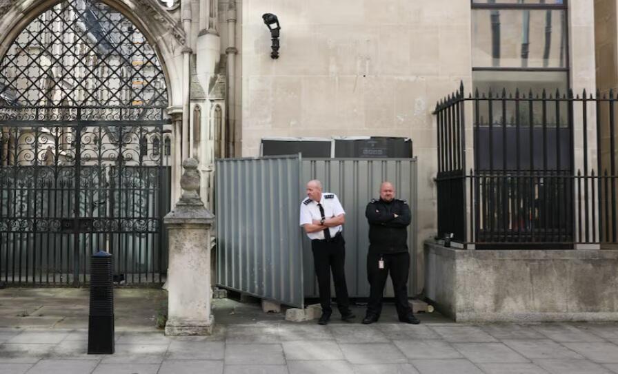 Security guards stand in front a screen covering a new mural by anonymous artist Banksy on the Royal Courts of Justice in London (Photo: Reuters) Security guards stand in front a screen covering a new mural by anonymous artist Banksy on the Royal Courts of Justice in London