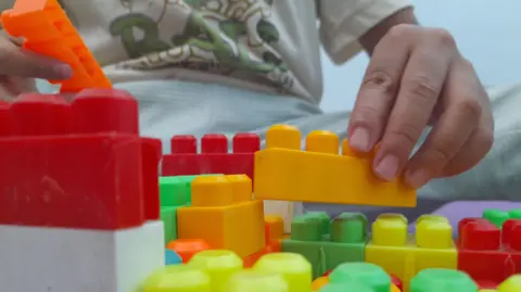Getty Images Child playing with building blocks