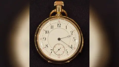 BNPS The pocket watch face which is stuck on the time 2:20am.