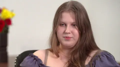 BBC Julia Wandelt has long dark hair and wears a purple top.