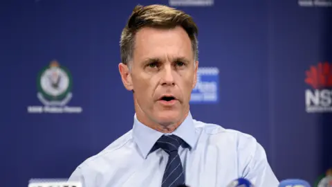EPA Close-up of Chris Minns wearing a blue shirt and tie at a press conference 