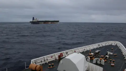 Reuters The shadow fleet ship Marinera seen in the distance from the upper decks of a US coastguard cutter following her.